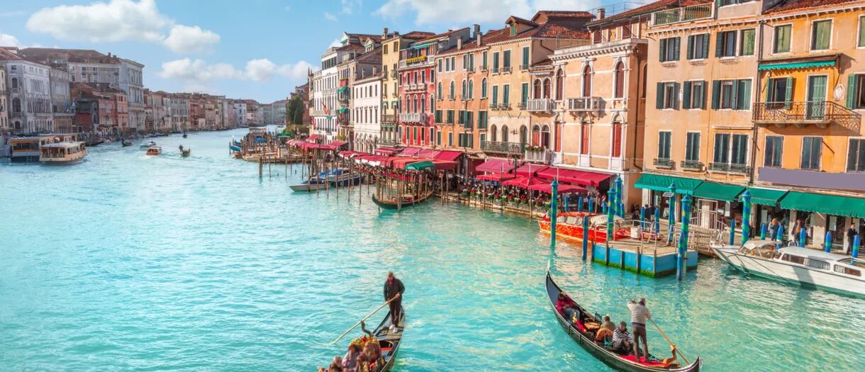 Venetian street full of colour by the canal.