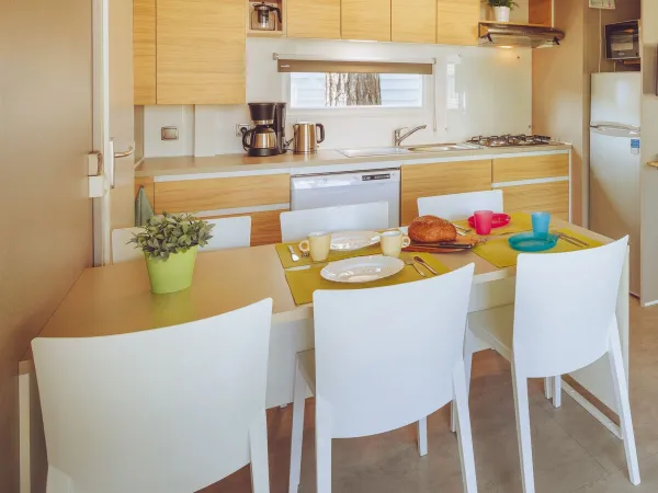 The Roan Premium Lounge features a cosy living room with dining table and kitchen.