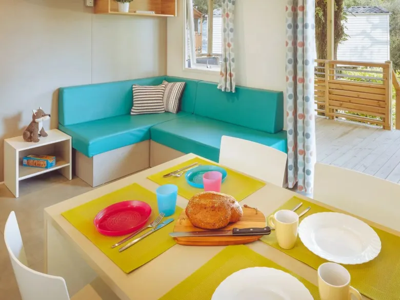 The Roan Premium Lounge living room features a cosy dining table and corner sofa.