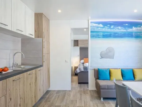 The Roan Premium Zone living room features a spacious kitchen and dining table.