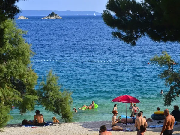 Beach with blue sea at Roan camping Amadria Park Trogir.