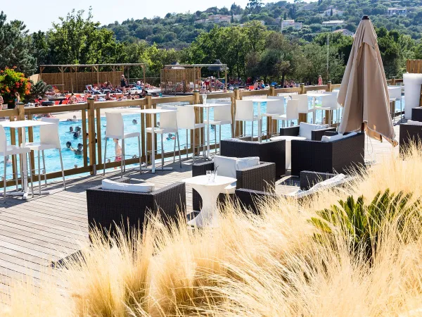 Pool terrace at Roan camping Domaine Naïades.