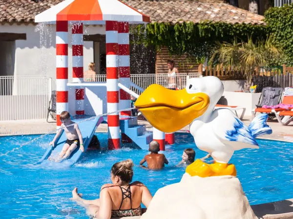 Children's pool with slide at Roan camping Domaine Naïades.