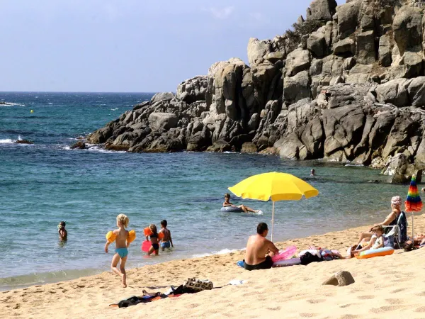 Beautiful beach by rocks close to Roan camping Cala Gogo.