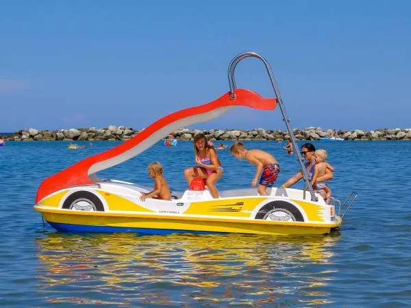 Pedal boat with slide in the sea at Roan camping Rubicone.