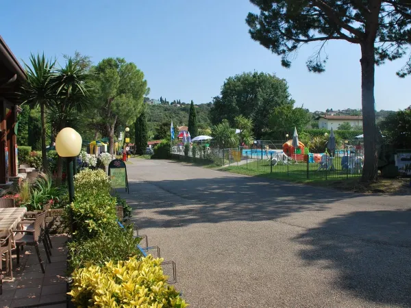 Overview of the terrace and playground at Roan camping La Rocca Manerba.