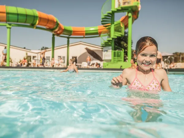 The outdoor pool with slide at Roan camping De Schatberg.