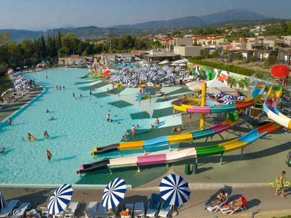 Pool complex with slides and a water playground at Roan camping Cisano San Vito.