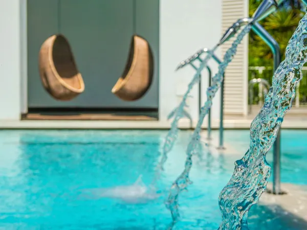 Hanging chairs by a pool at Roan campsite Union Lido Mare.