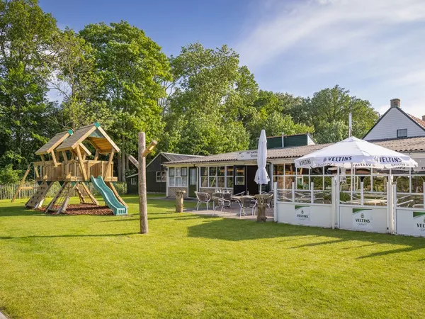 The terrace with playground at Roan camping Marvilla Parks Friese Meren.