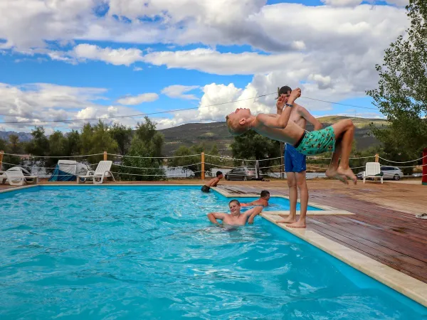 Playing youngsters in the pool at Roan camping Karin.