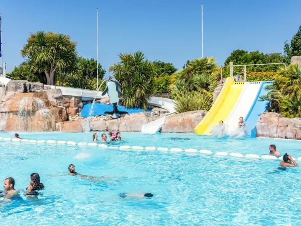 Outdoor pool with slides at Roan camping Le Domaine du Clarys.
