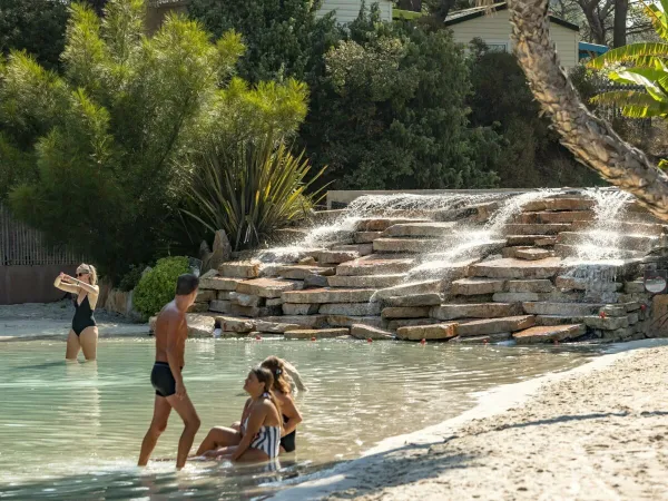 Sitting children in the lagoon at Roan camping La Pierre Verte.