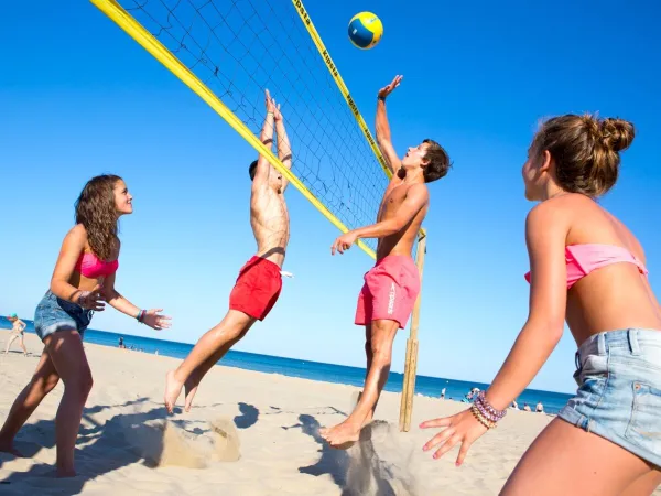 Playing beach volleyball at Roan camping Beach Garden.