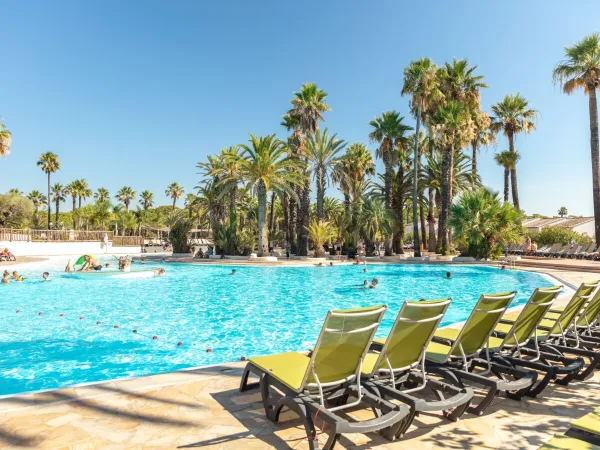 Swimming pool and sunbeds at Roan camping La Baume.