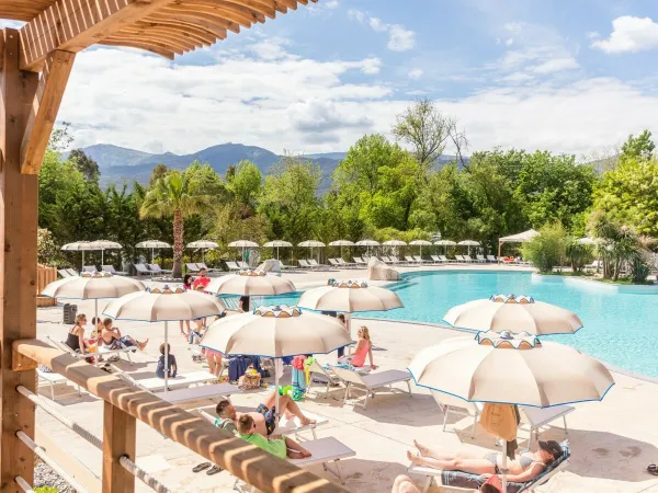 Sunbeds by pool at Roan camping La Chapelle.