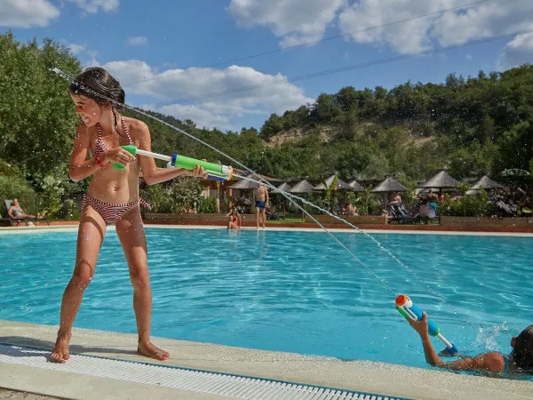Water gun fight by pool at Roan camping Verdon Parc.