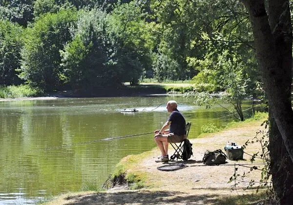 Man fishing in the Loire at Roan campsite Domaine de la Brèche.