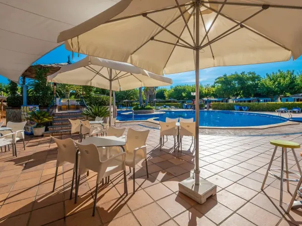 Terrace by the pool at Roan camping La Masia.