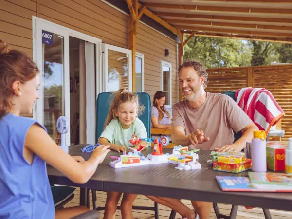 Family plays a game on the decking.