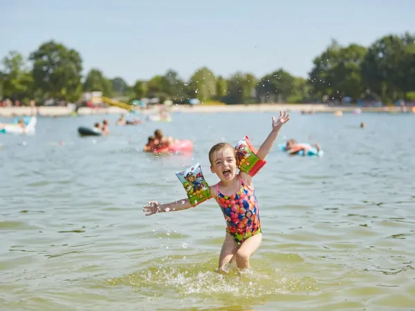 Happy girl in the swimming pool at Roan camping Terspegelt.