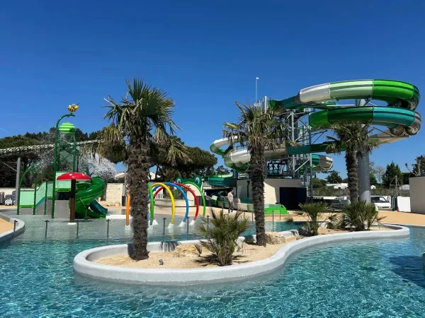 Renewed swimming pool with cool slides and water playground at Le Domaine du Clarys campsite.