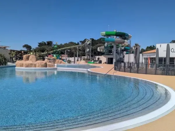Overview swimming pool with new slides at Roan camping Le Domaine du Clarys.