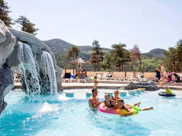 A family in the pool at Roan campsite Les Collines de Castellane.