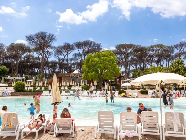 People enjoying themselves by the lagoon pool at Roan camping hu Fabulous village.