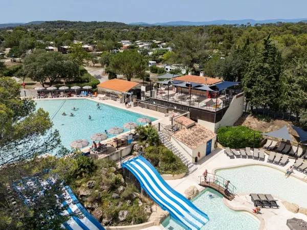 The swimming pool with slides at Roan camping Domaine de la Noguière.