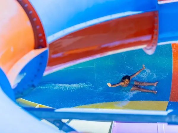 Girl slides into the toll at Roan campsite Le Soleil Méditerranée.