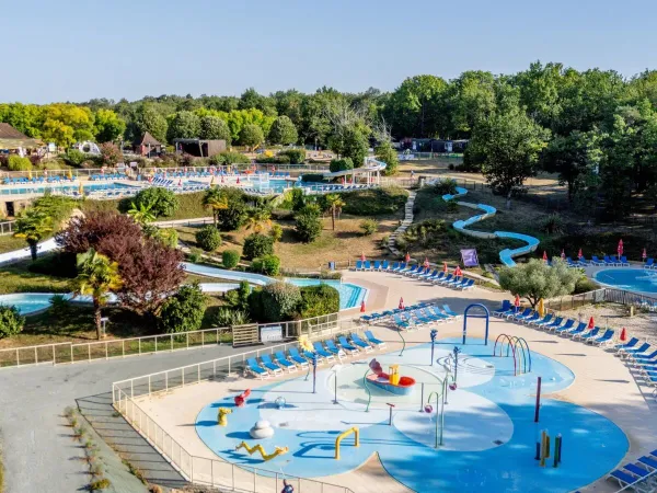 Overview of the water park and pools in the distance at Roan camping Saint Avit Loisirs