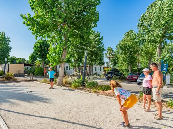Family plays petanque at Roan camping Le Napoléon.