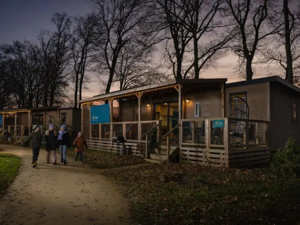Children stroll past the atmospheric mobile homes in winter at Roan campsite Marilla Parks Kaatsheuvel.