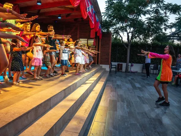 Dancing children with the entertainment at Roan campsite Alannia Els Prats.