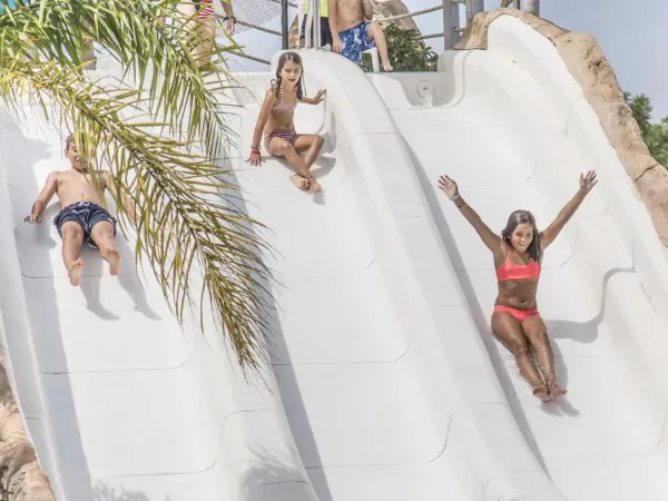 Children on slides at Roan campsite Alannia Els Prats.