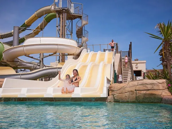 Girls slide down the slide at Roan campsite Le Petit Mousse.