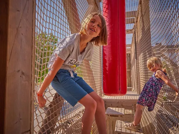 Playing and climbing children in the climbing frame at Roan campsite Le Petit Mousse.