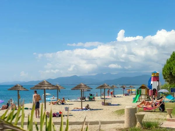 Holidaymakers enjoy the lovely sandy beach at Roan campsite Arinella Bianca.