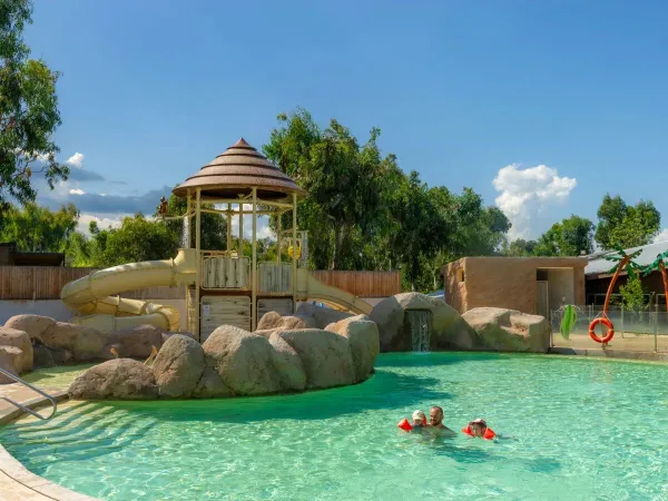 Father and kids swim in the pool at Roan campsite Arinella Bianca.