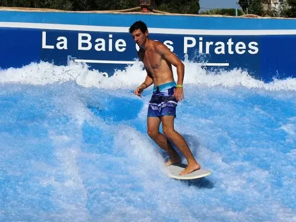 Learn to surf on a surf simulator at Roan campsite Les Sables d'Or.