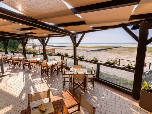 Restaurant overlooking the beach and sea at Roan campsite Tenuta Primero.