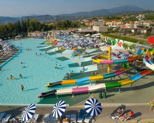 Pool complex with slides and a water playground at Roan camping Cisano San Vito.